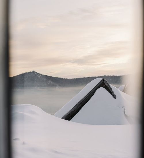 Smiling person stretching outdoors at sunrise.
